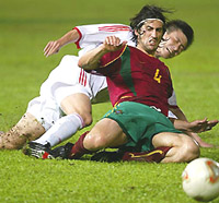 China's Hao Haidong is tackled by Portugal's Marco Caneira 