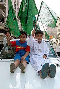 Pakistani children hold flags