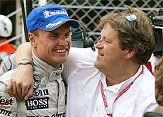 West McLaren Mercedes driver David Coulthard of Great Britain is congratulated by Mercedes technical director 