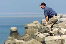 A relative of a passenger on the crashed China Airlines flight calls out to his father