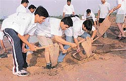 Staff of a bank take part in shramdan at Sukhna Lake on Monday morning.