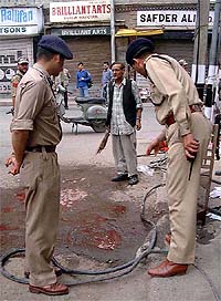 Police officers inspect the spot