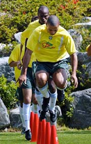 Brazilian striker Ronaldo and Edilson jump over plastic cones during a practice session in Ulsan, Korea, on Monday. 