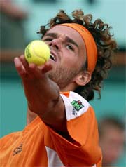 Gustavo Kuerten of Brazil prepares to serve against Ivo Heuberger of Switzerland during their first round match at the French Open on Monday.