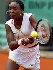 Venus Williams of the USA returns a backhand to Bianka Lamade