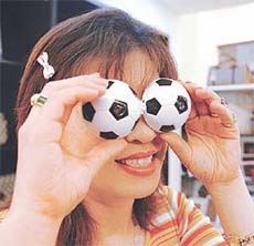 South Korean store owner Shin Ha-Na displays a pair of binoculars