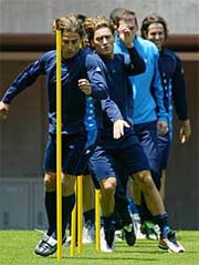 Italy's (L-R) Fabio Cannavaro, Francesco Totti, Christian Abbiati and Cristiano Doni run through poles 