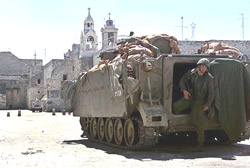 An Israeli soldier steps out of an armoured personnel carrier guarding the entrance of the Church of Nativity in Bethlehem on Tuesday.