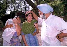 Lt-Col (retd) Avtar Singh Parmar consoles his son Captain Satnam Singh Parmar's widow