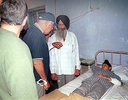 Jammu and Kashmir Chief Minister Farooq Abdullah talks to an injured child