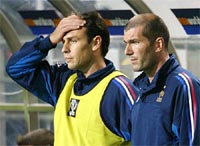France's Alain Boghossian holds his head 