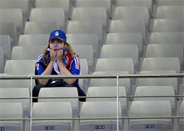 A France fan sits alone in the stands