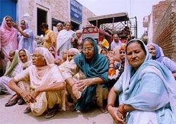 Residents block the way of a tractor-trailer