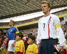 England's David Beckham arrives on the field with Sweden's Johan Mjallby