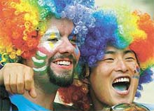 Fans with multi-coloured wigs