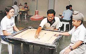 Arun Kedar gives tips on carrom to children at St. Stephen�s School, Sector 45, Chandigarh, on Monday.