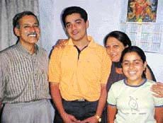 Sahil Nagpal who topped in CET conducted by Panjab University with his family in Ambala on Monday.