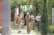 Investigators coming out of the farm house, Eros Garden.