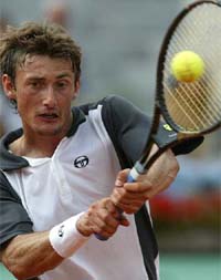 Juan Carlos Ferrero of Spain returns a backhand