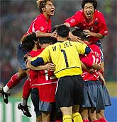 The South Korean team celebrate after defeating Poland