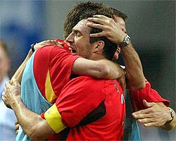 Belgium's captain Marc Wilmots is embraced by team mates