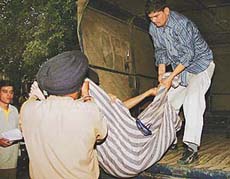 Policemen put away the body of Eknarayan in a truck to take it to hospital for a post-mortem examination, in Chandigarh on Wednesday. 