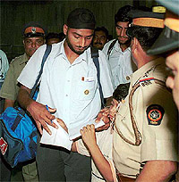 Harbhajan Singh signs an autograph for a fan on his arrival