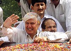 Aftab Sherpao, former Chief Minister of Pakistan's Northen province and leader of Bhutto's People's Party, waves his supporters outside the central jail in Peshawar