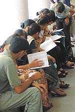 Students filling up admission forms at one of the centres of Delhi University in the Capital on Thursday.