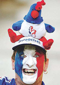 A French soccer fan smiles before the group A match between France and Uruguay at the World Cup finals in Pusan on Thursday.