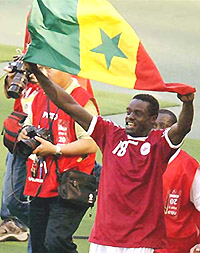 Senegal's Papa Malick Diop waves his national flag after Senegal drew 1-1 against Denmark in their World Cup finals match in Taegu on Thursday.