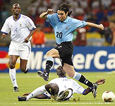 Uruguay's Alvaro Recoba (20) jumps over France's Lilian Thuram as France's Patrick Vieira looks on during their group A match at the World Cup finals in Pusan on Monday.