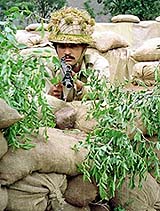 A Pakistani soldier takes position in a bunker