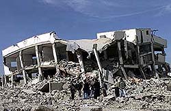 Palestinians stand in front of Palestinian leader Yasser Arafat's compound