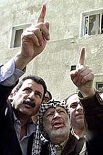 Palestinian leader Yasser Arafat views damage