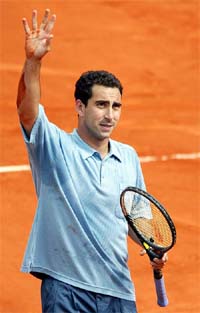 Alberto Costa of Spain waves to the public after defeating compatriot Alex Corretja