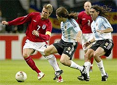 England's captain David Beckham fights for the ball