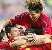 Spain's Carles Puyol and Fernando Morientes celebrates with team-mates