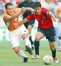 Paraguay's Carlos Gamarra and Spain's Raul tussle for the ball