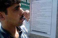 A curious Kashmiri reads posters