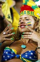 Brazilian soccer fan shows her fingernails in the colours of the Brazilian flag