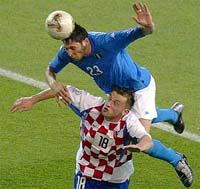 Italy�s Marco Materazzi outjumps Ivica Olic of Croatia