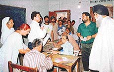 Congress and Akali workers argue over bogus voting at the Trivedi Camp polling station in Mubarikpur village, near Dera Bassi, on Sunday.