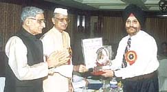Mr S.S. Minhas, principal of GHPS, Vasant Vihar, being presented the Vijay Ratan Award by Dr Bhai Mahavir, Governor of Madhya Pradesh, in the Capital.�