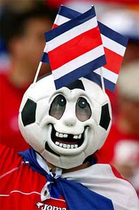 A fan cheers for the Costa Rican team prior to a Group C World Cup finals match