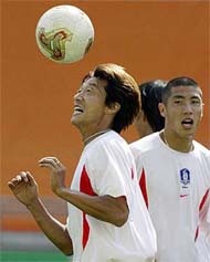 South Korea's Hwang Sun-hong controls the ball