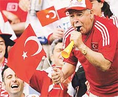 A Turkey supporter parties in the stands before the group C World Cup finals match