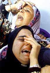 The mother and the sister of Ahad Al Mbasher, 20, who was killed by Israeli soldiers