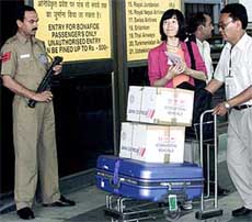 A Japanese couple arrive at the entrance of New Delhi International Airport
