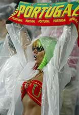 A Portugal fan holds a team scarf high over her head